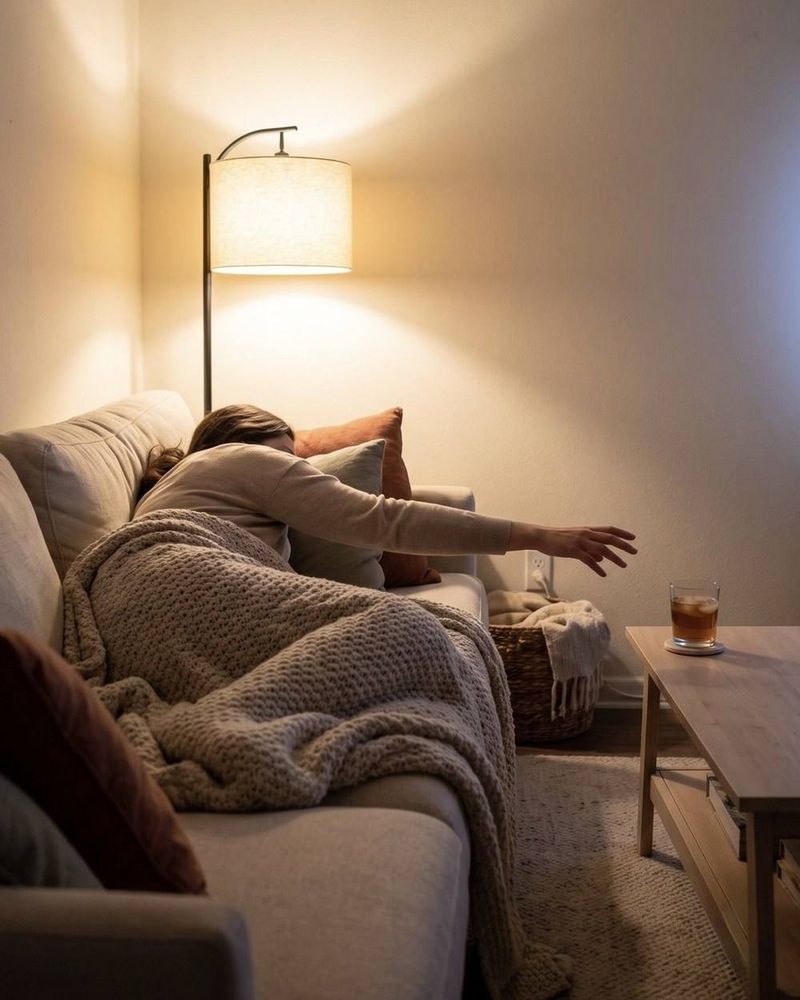 A full-arm stretch from the couch to a glass on the coffee table.