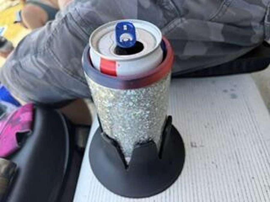 A black Steadi on a grandstand bench holding a can in a glitter koozie.